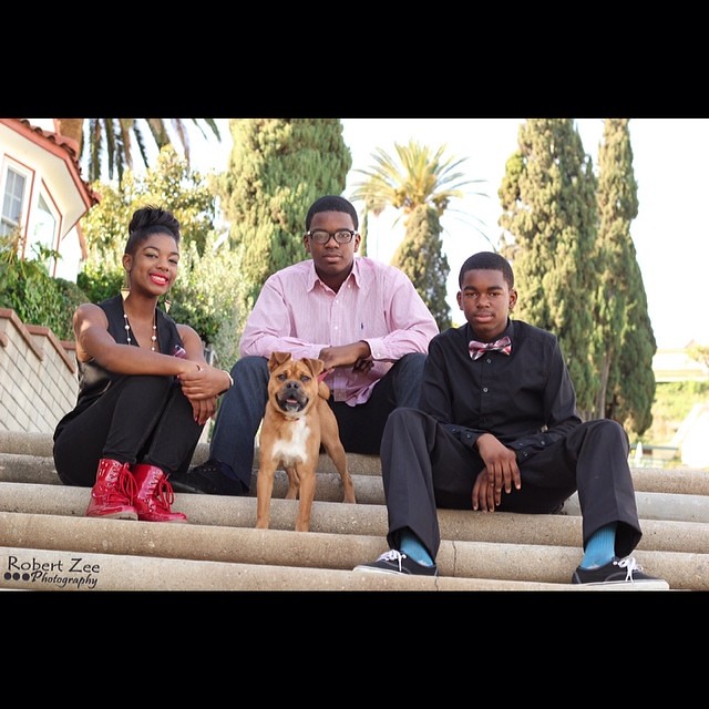 A family with their dog on outdoor steps, photographed by Robert Zee